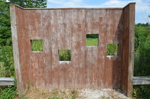 wood animal blind with square holes or viewing windows