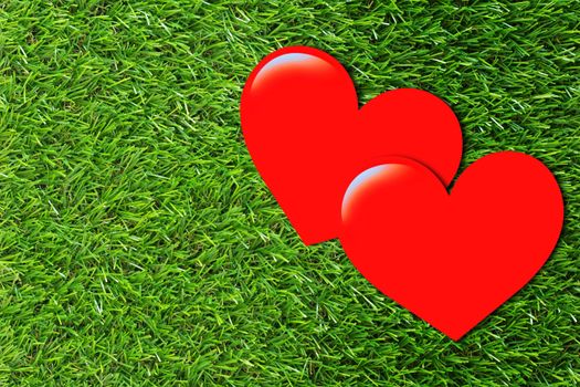 Two red paper hearts on green grass background, valentine day, romantic and falling in love concept