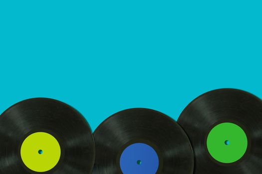 Music concept, record on blue background, retro and vintage tone