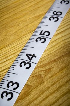 White tailor meter on a wooden table