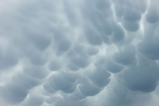 Menacing mammatus clouds before the storm, stormy sky, climate change and unpredictable terrifying mother nature