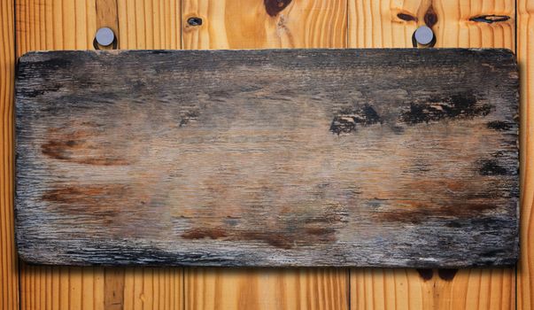 Old wood sign on plank background, vintage and retro
