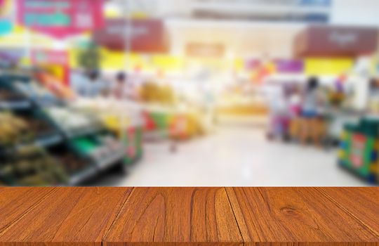 Wood table on food product shelf in supermarket, montage or display product concept