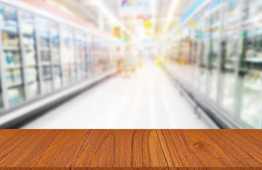 Wood table on food product shelf in supermarket, montage or display product concept