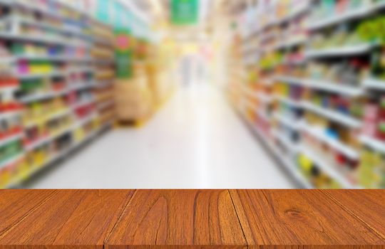 Wood table on food product shelf in supermarket, montage or display product concept
