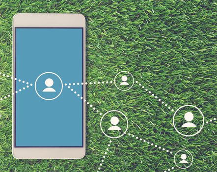Social network concept, internet media, mobile phone on green grass background