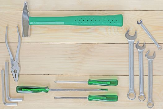 Tool set on wood background, top view, flat lay style