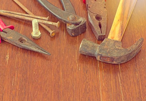 Old tools on wood background, old equipment concept, vintage and retro tone style