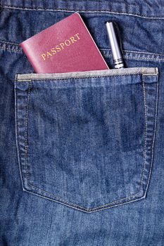 Passport and pen in blue jean pocket, traveling concept, tourism concept