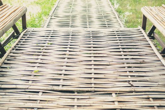 wooden bamboo footbridge bridge in rice paddy field