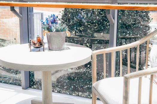 fake plant flower in metal tin bucket. chair in living room home interior