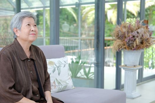 asian elder female woman resting relaxing on sofa at home. elderly senior leisure lifestyle