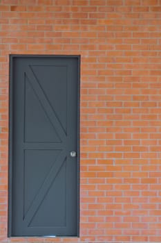 new gray wooden door & orange brick wall