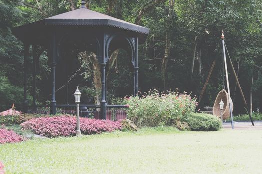 gazebo pavilion for resting in garden park. tranquil nature scene