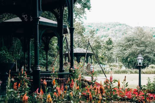 gazebo pavilion for resting in garden park. tranquil nature scene