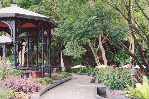gazebo pavilion for resting in garden park. tranquil nature scene