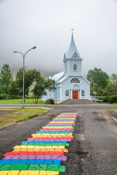 Seydisfjordur, Iceland. Rainbow path to the church, fog in the background.