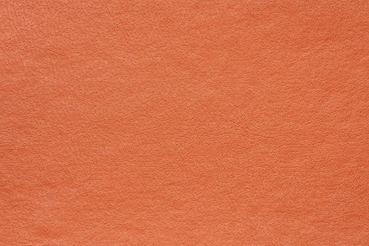 Synthetic orange leather for background. Close-up detail macro photography view of texture decoration material, pattern background design for poster, brochure, cover book and catalog.