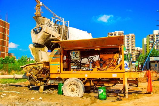 cement mixer working near the big construction area