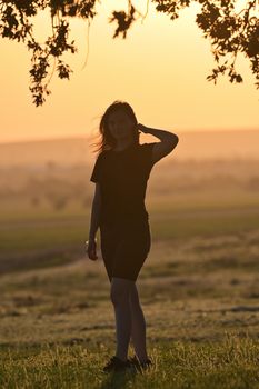 Portrait of young woman silhouette at sunset