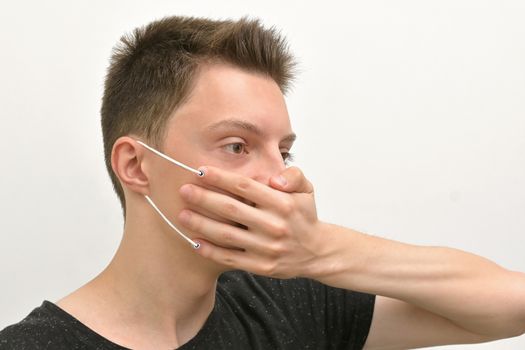 Conceptual  Portrait Of Young Man Wearing Medical Mask