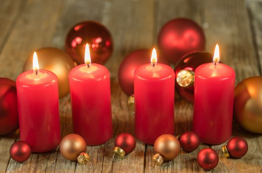 Christmas or advent red candles with balls ornaments decoration