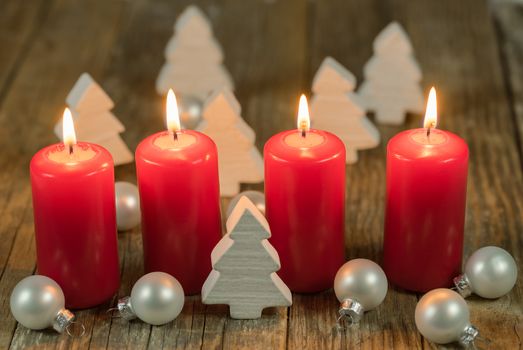 Merry Christmas decoration advent with burning red candles and white ornaments