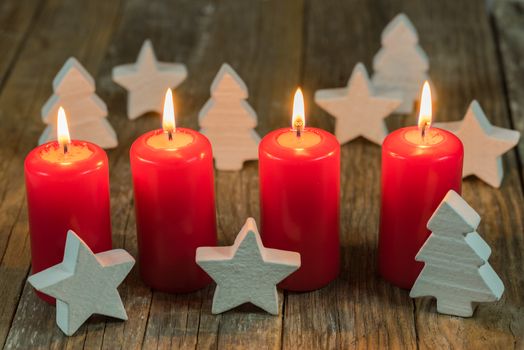 Merry Christmas decoration advent with burning red candles and white ornaments
