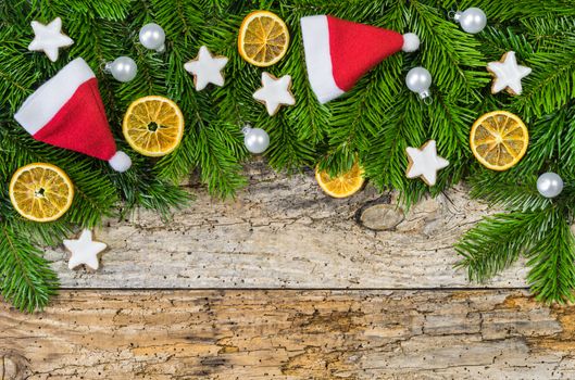 Wooden background with fir tree branches and christmas decoration