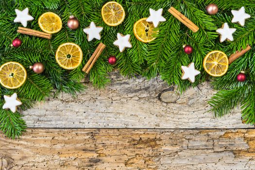 Christmas decoration on wooden background with fir tree border