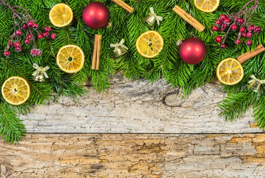 Xmas decoration on rustic wooden background with fir tree and christmas ornaments