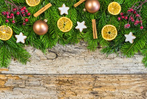 Christmas decoration with fir green and ornaments on old wood