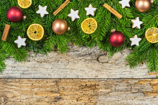 Xmas decorations with fir tree branches on wooden background with text space