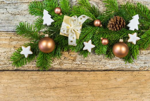 Christmas decoration with gift box, ornaments and fir branch on rustic wood background, copy space