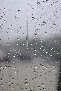 Drops of rain on the window, rainy day. Shallow DOF