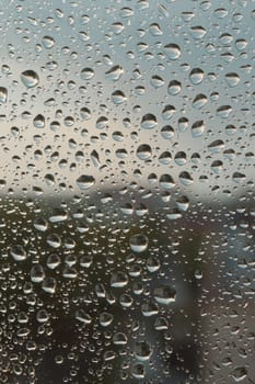 Drops of rain on the window, rainy day. Shallow DOF