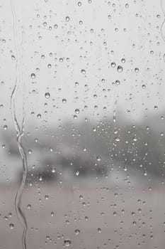 Drops of rain on the window, rainy day. Shallow DOF