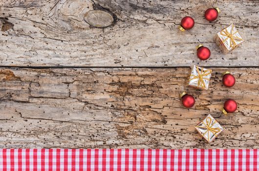 Christmas border with ornaments on rustic wooden table, top view