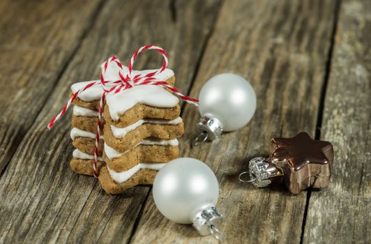 Stack of christmas cookies gift with decorations on wood background