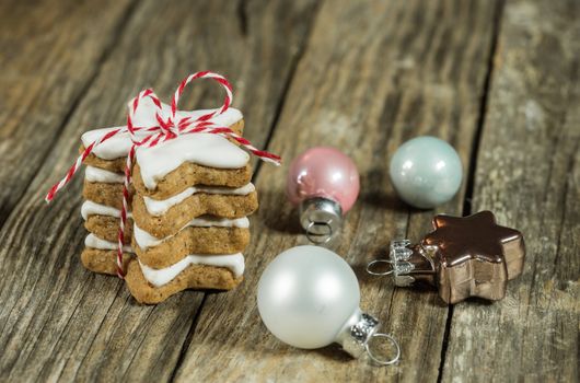 Stack of christmas star biscuits with decoration on wood background