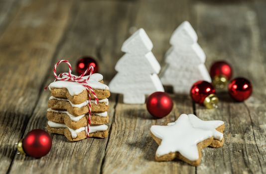 Composition with star shape biscuits and red white christmas decorations