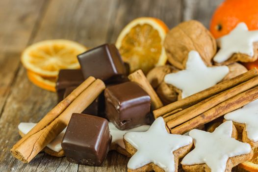 Christmas food, star biscuits, chocolate and spices on wooden table