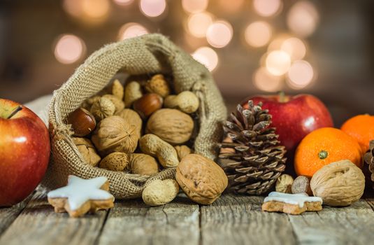 Christmas food composition on wooden table with blurred lights background