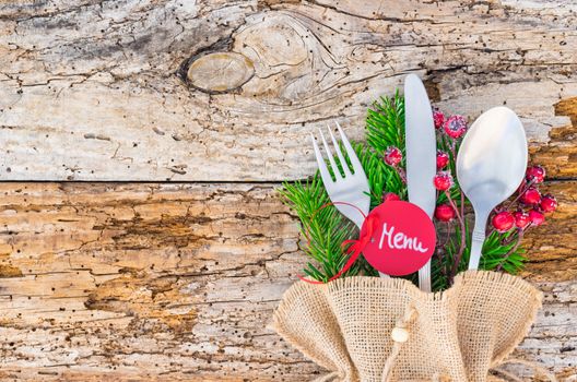 Christmas dinner wooden table place setting with menu tag