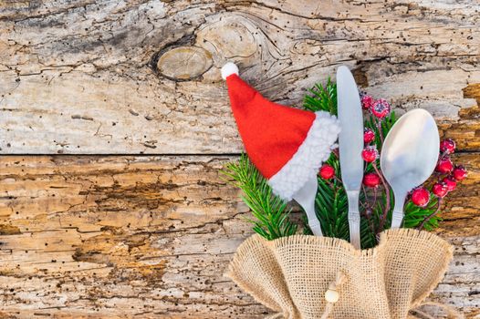 Advent or Christmas table place setting with pine branches, santa claus hat, Christmas holidays background