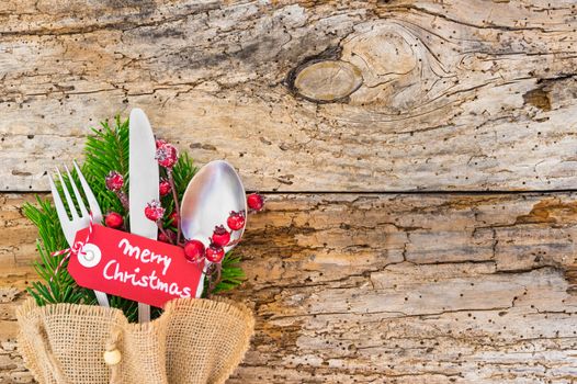 Christmas holiday season, table place setting on rustic wooden table