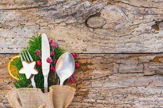 Christmas table place setting on wood background, copy space