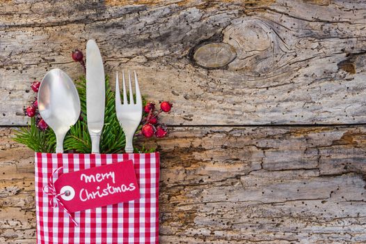 Christmas table place setting with tag Merry Christmas, holidays celebration background