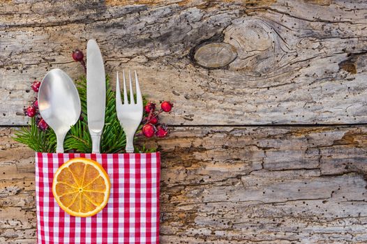 Christmas dinner menu cutlery on rustic wooden table background, copy space