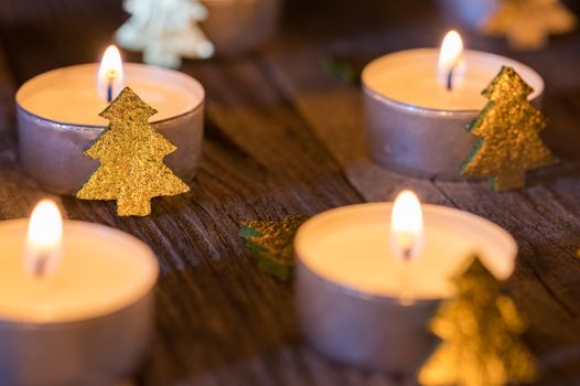 Christmas or Advent candles with golden christmas trees decoration